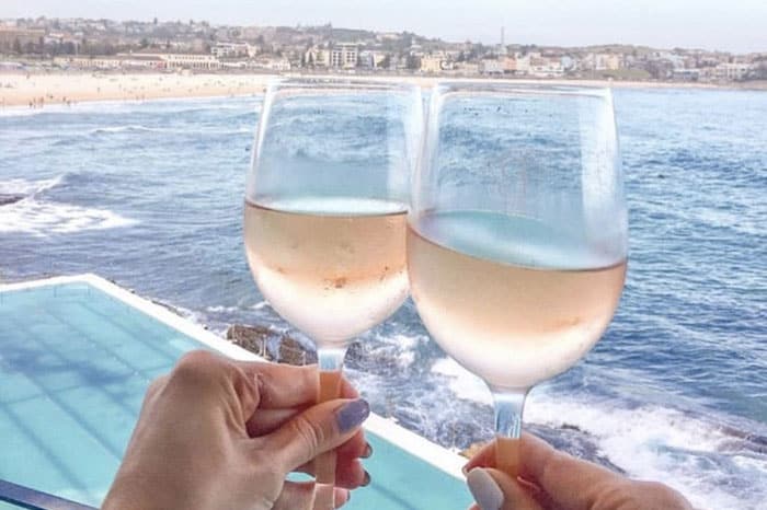 Two wine glasses with image of Bondi Beach from icebergs